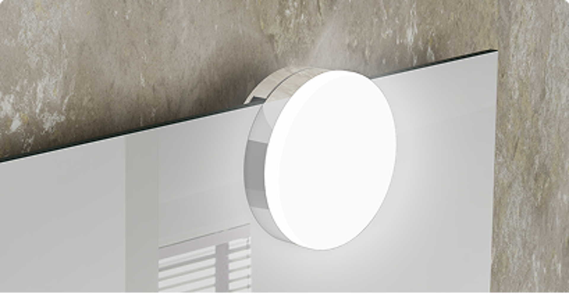 Detail van ronde LED-verlichting gemonteerd op een badkamerspiegel, geplaatst tegen een betonnen muur – verkrijgbaar bij x²o badkamers.